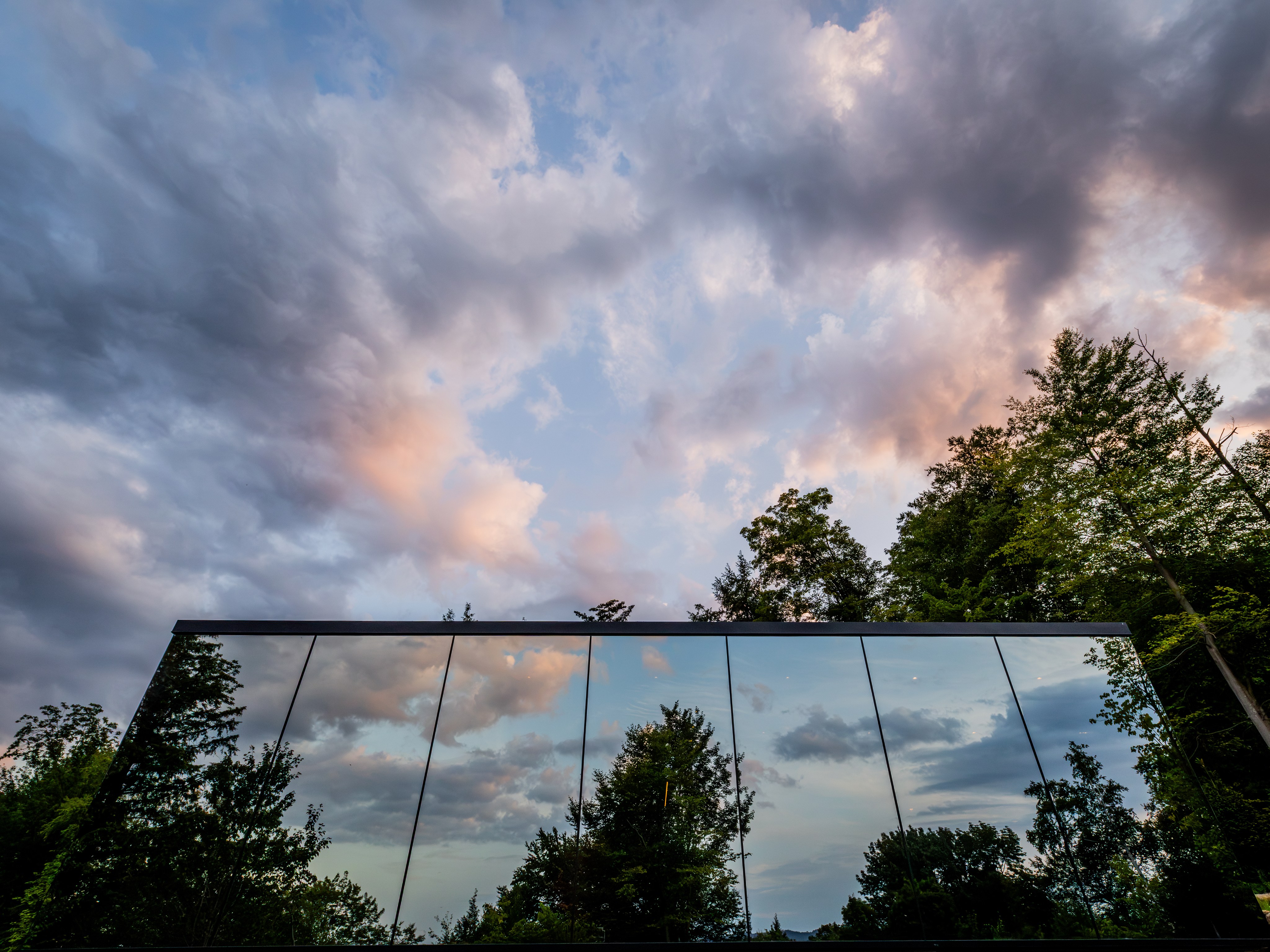 Clouds reflected in the mirrored cabin exterior