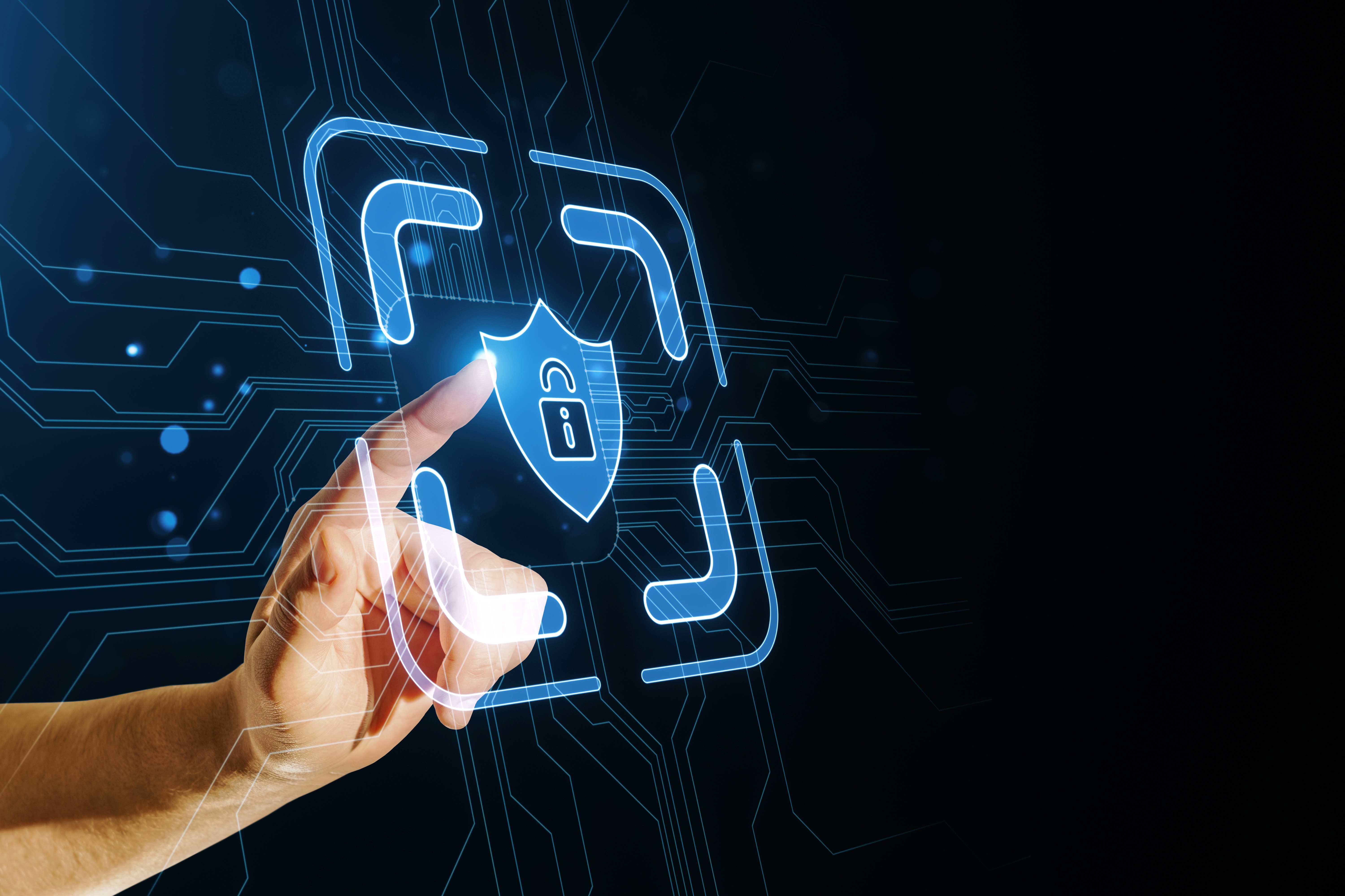 A hand interacting with a digital hologram of a security shield, with a futuristic circuit background