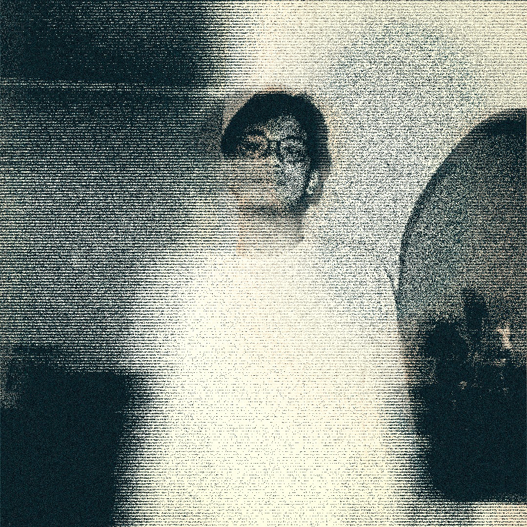a blurry photo of a person standing in front of a wall