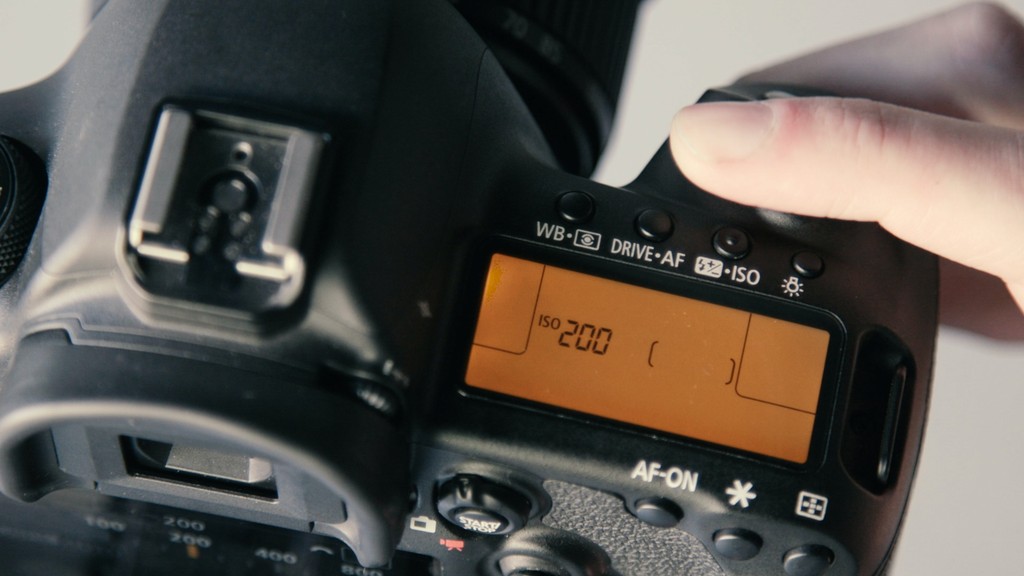 Camera with orange top display showing ISO 200