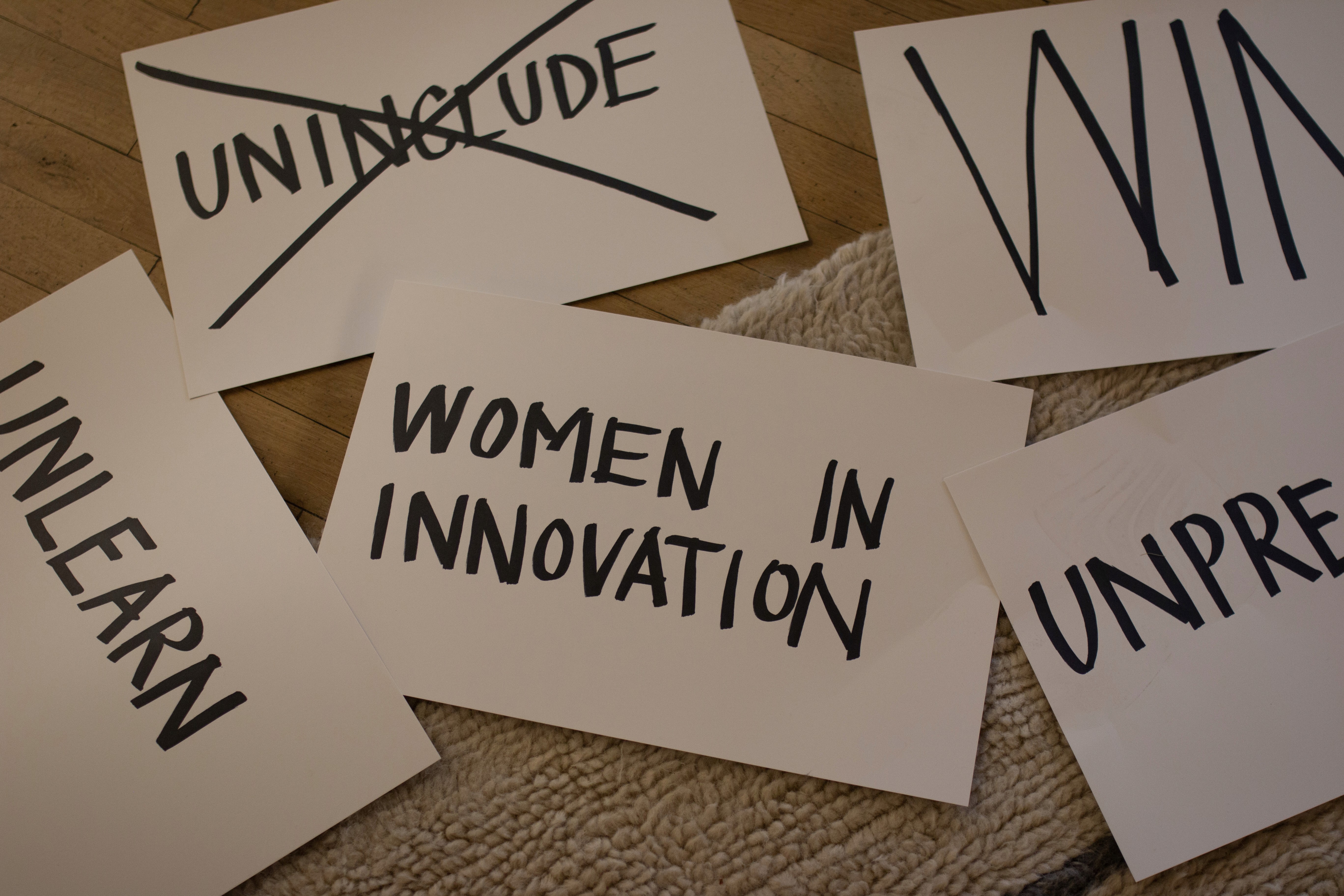 Cards with "Unlearn", "Women in Innovation" and WIN. One card is crossed out and reads "Uninclude"