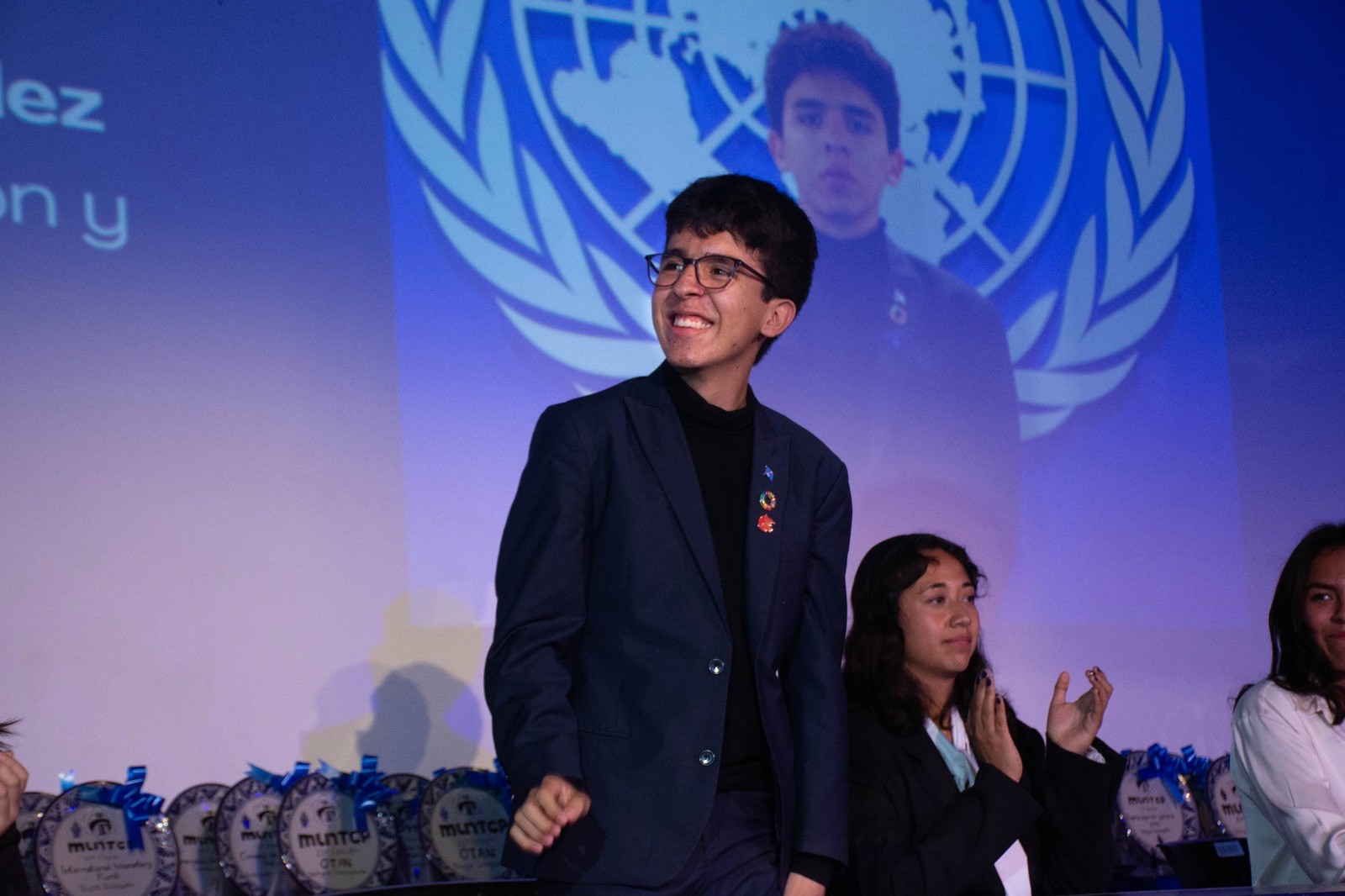 A person stands in a sandstone cave.