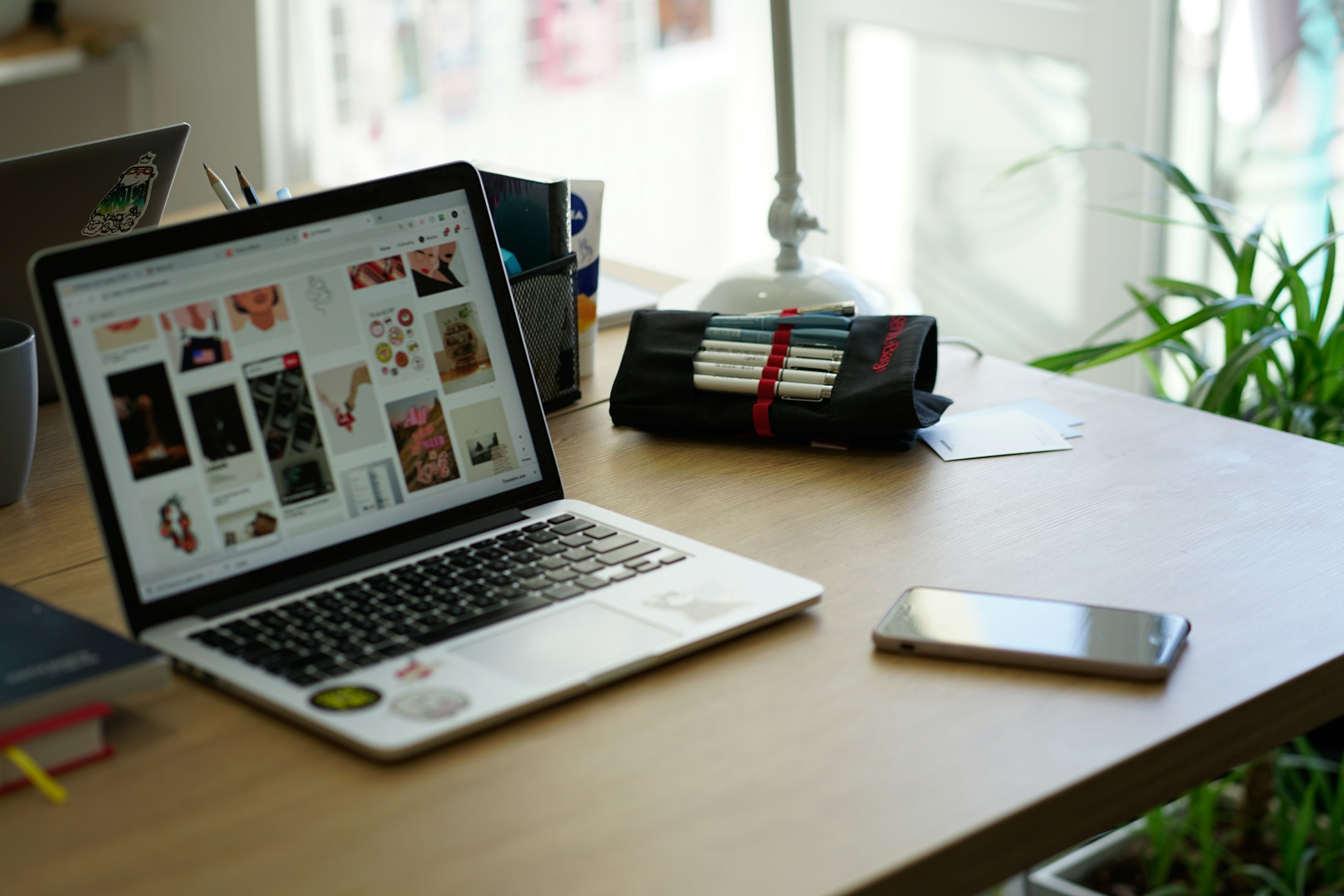 Laptop and phone on a warm timber table