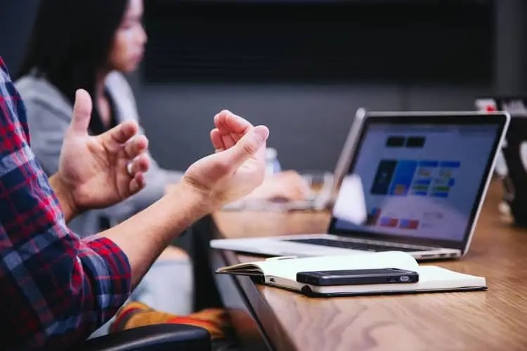 a man using hand gestures in a meeting