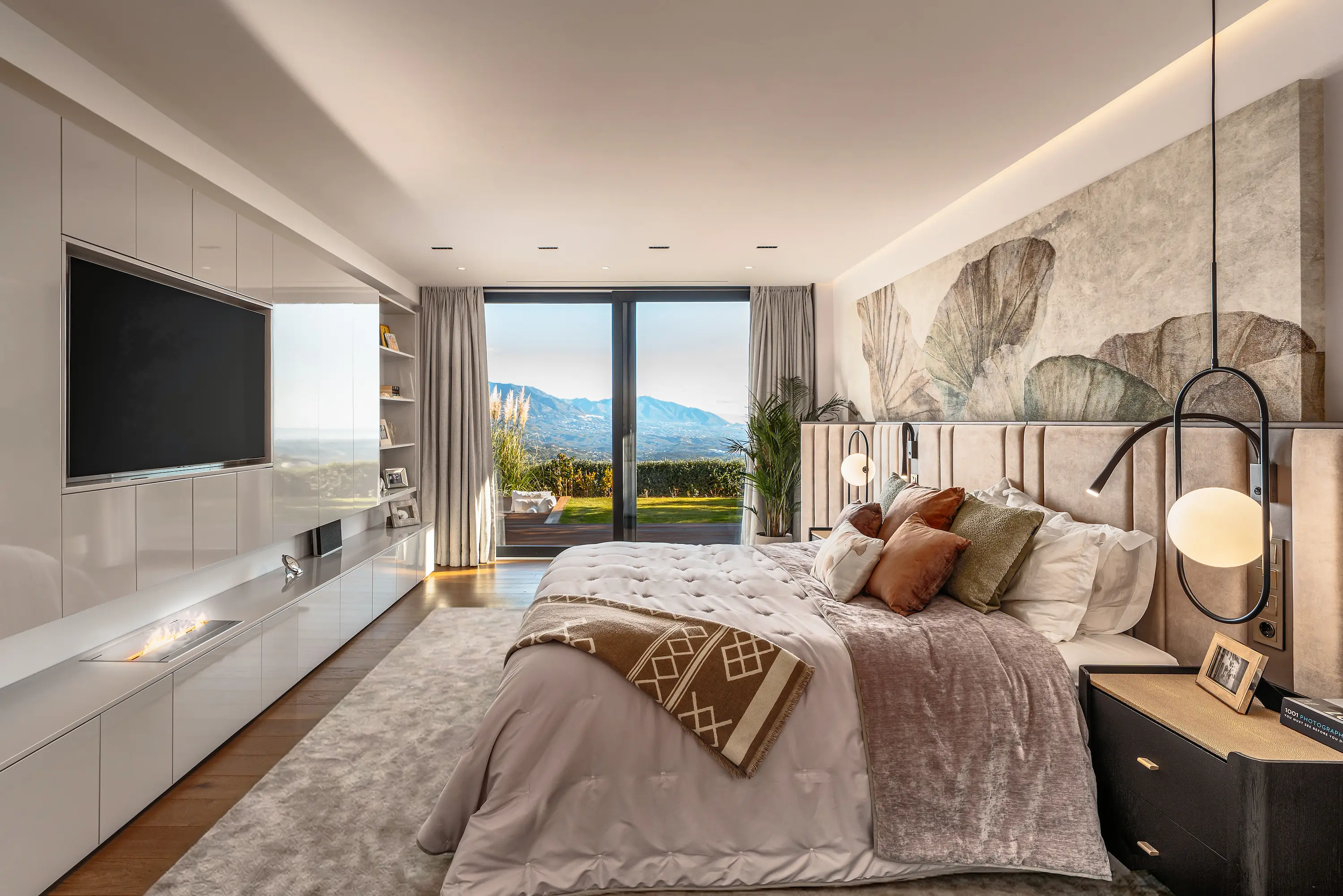 Villa Vista Marbella master bedroom with custom wall mural, built-in cabinetry, and mountain-view glazing