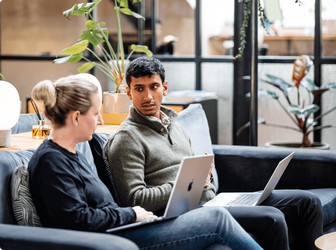 Man on laptop looking at code on screen