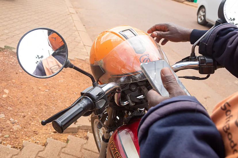 A SafeBoda driver using his smartphone. Credit: Katumba Badru Sultan, for Lubyanza.