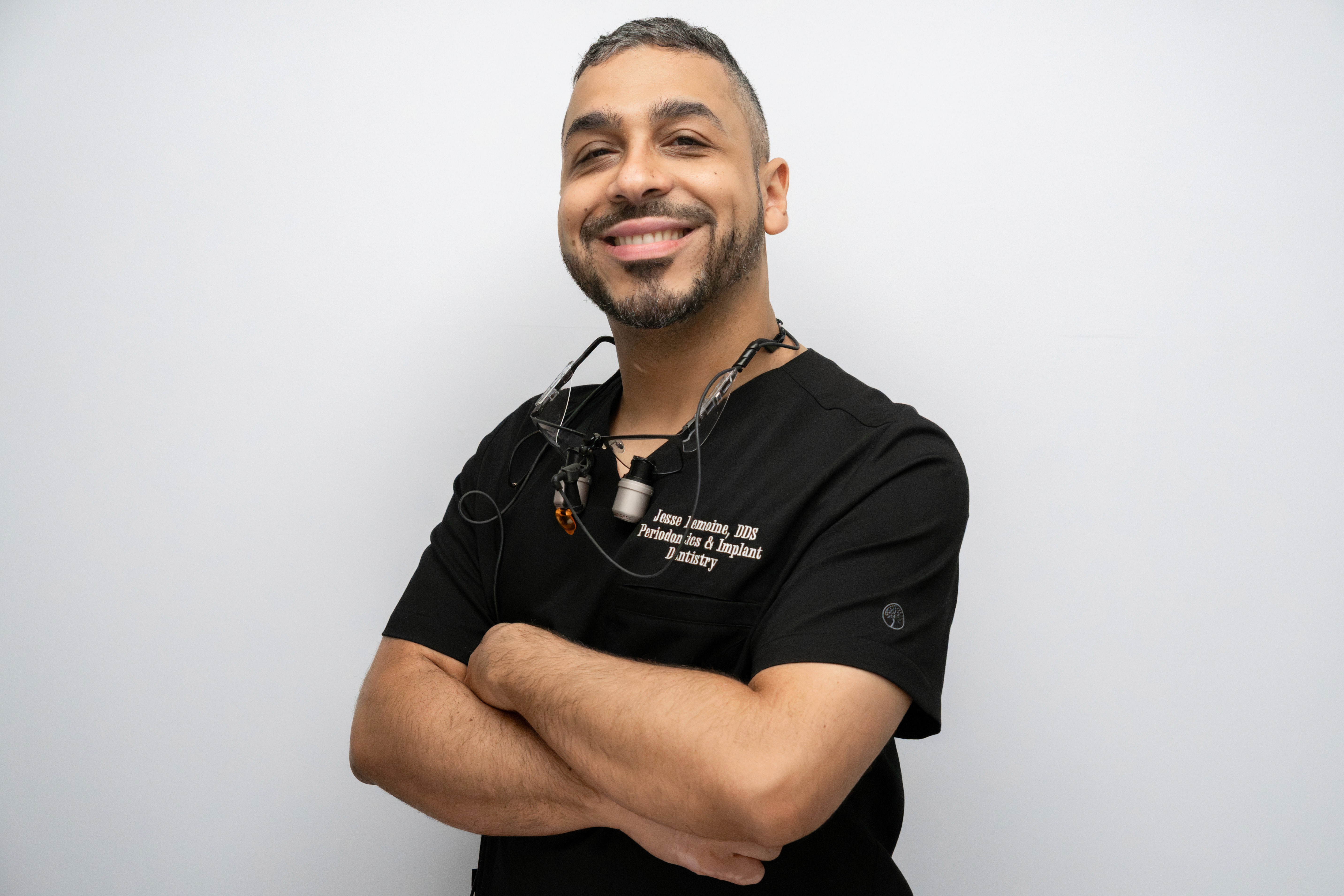 Dr. Jesse Lemoine, board-certified periodontist and co-founder of Gardens Implant and Cosmetic Dentistry, wearing surgical loupes