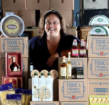 A barista is making coffee behind a counter.