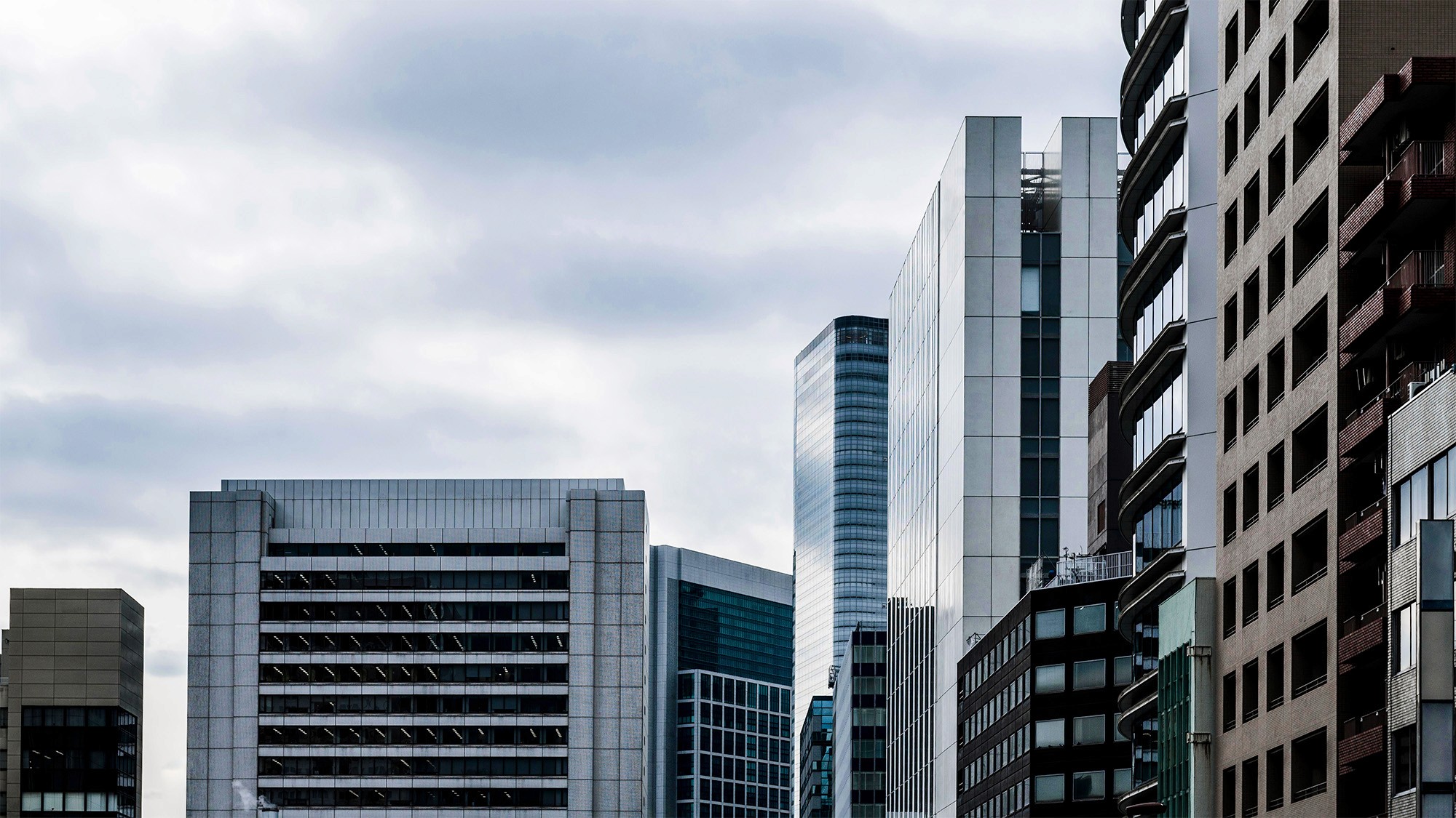 Skyline of modern office buildings under cloudy skies