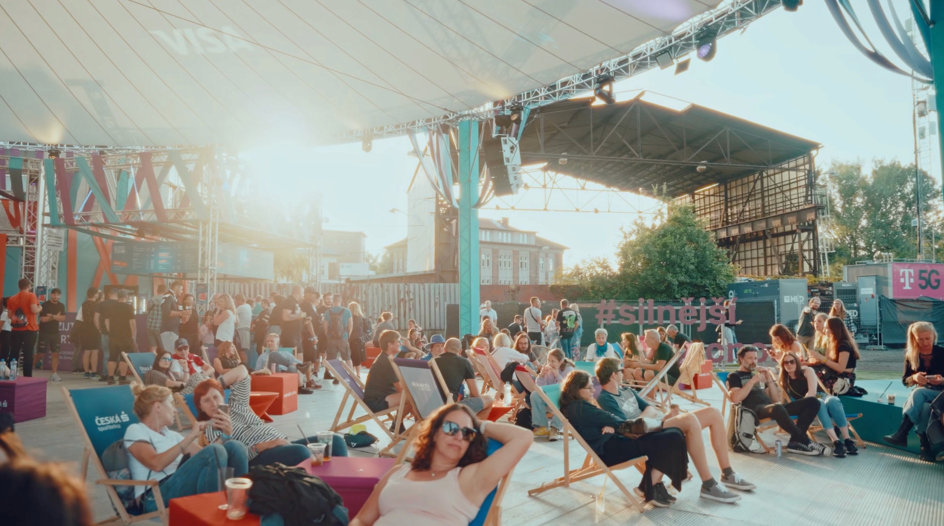 a crowd of people walking around a market