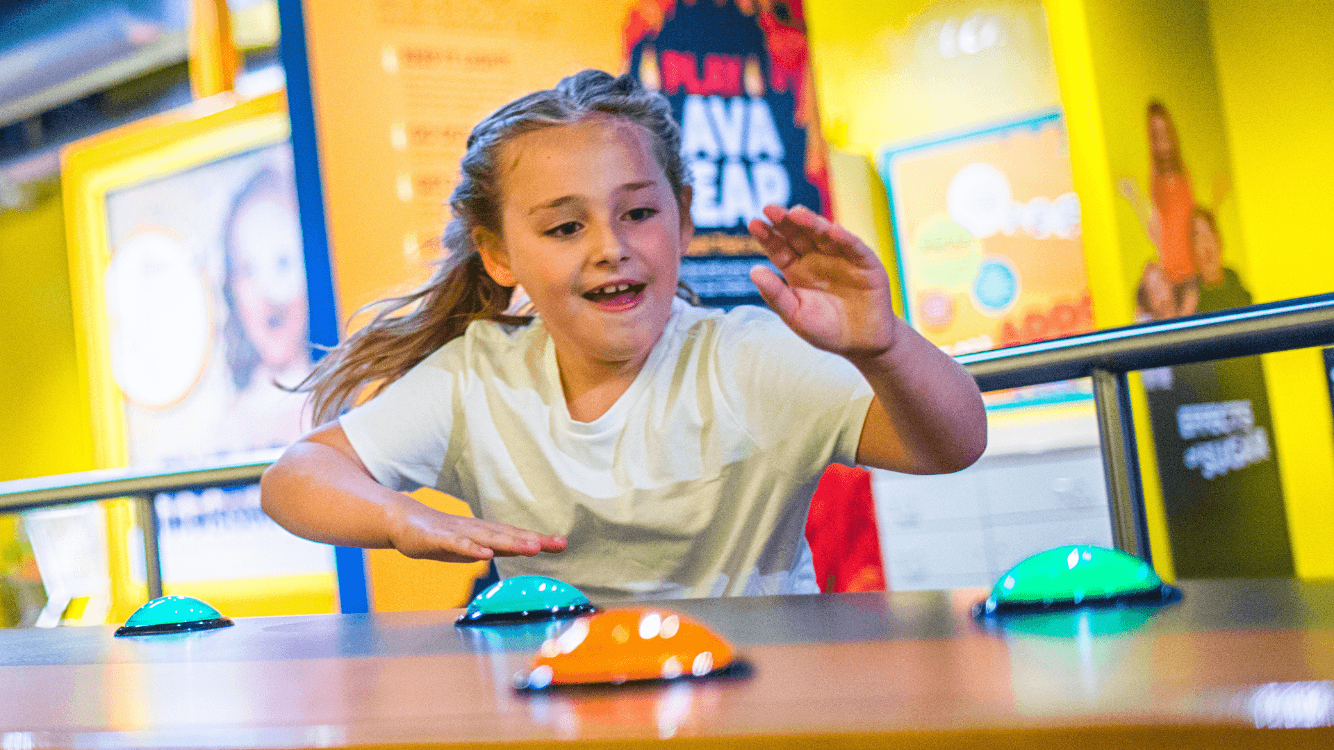 A young girl races to hit the light up buzzer at the Heart Rate Rally.