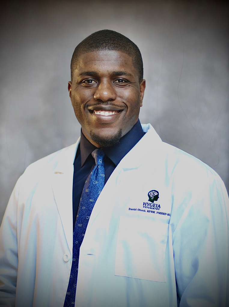 A lone figure stands on a vast beach at sunset.