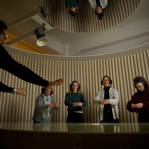 Guests have their task explained to them by a deaf guide.