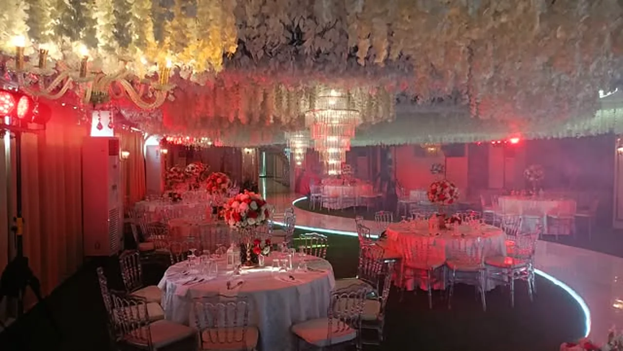 Round banquet tables set for a corporate celebration under the wisteria ceiling of Celestia Hall, Quezon City
