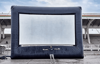 An outdoor cinema screen in a stadium