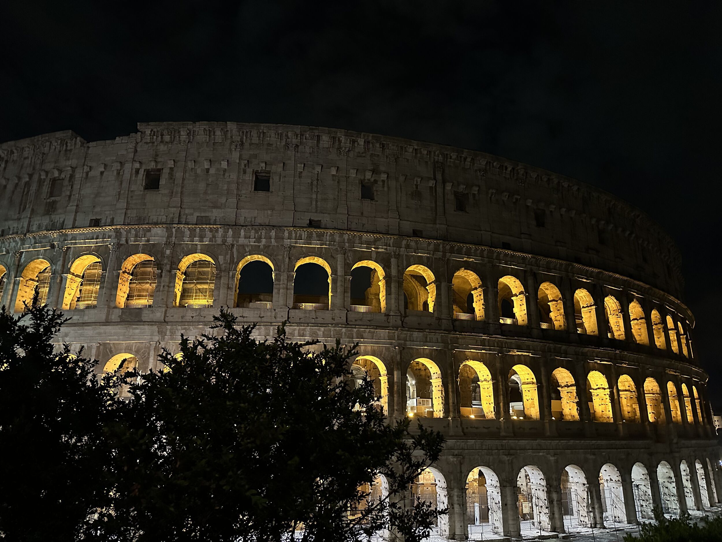 Colosseo north arches glowing after sunset above Piazza del Colosseo, Rione Monti, Rome