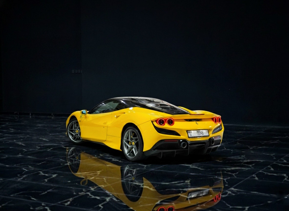 Ferrari F8 Tributo rear side view in yellow, showcasing aggressive coupe styling, sculpted aerodynamics, and iconic Ferrari performance.