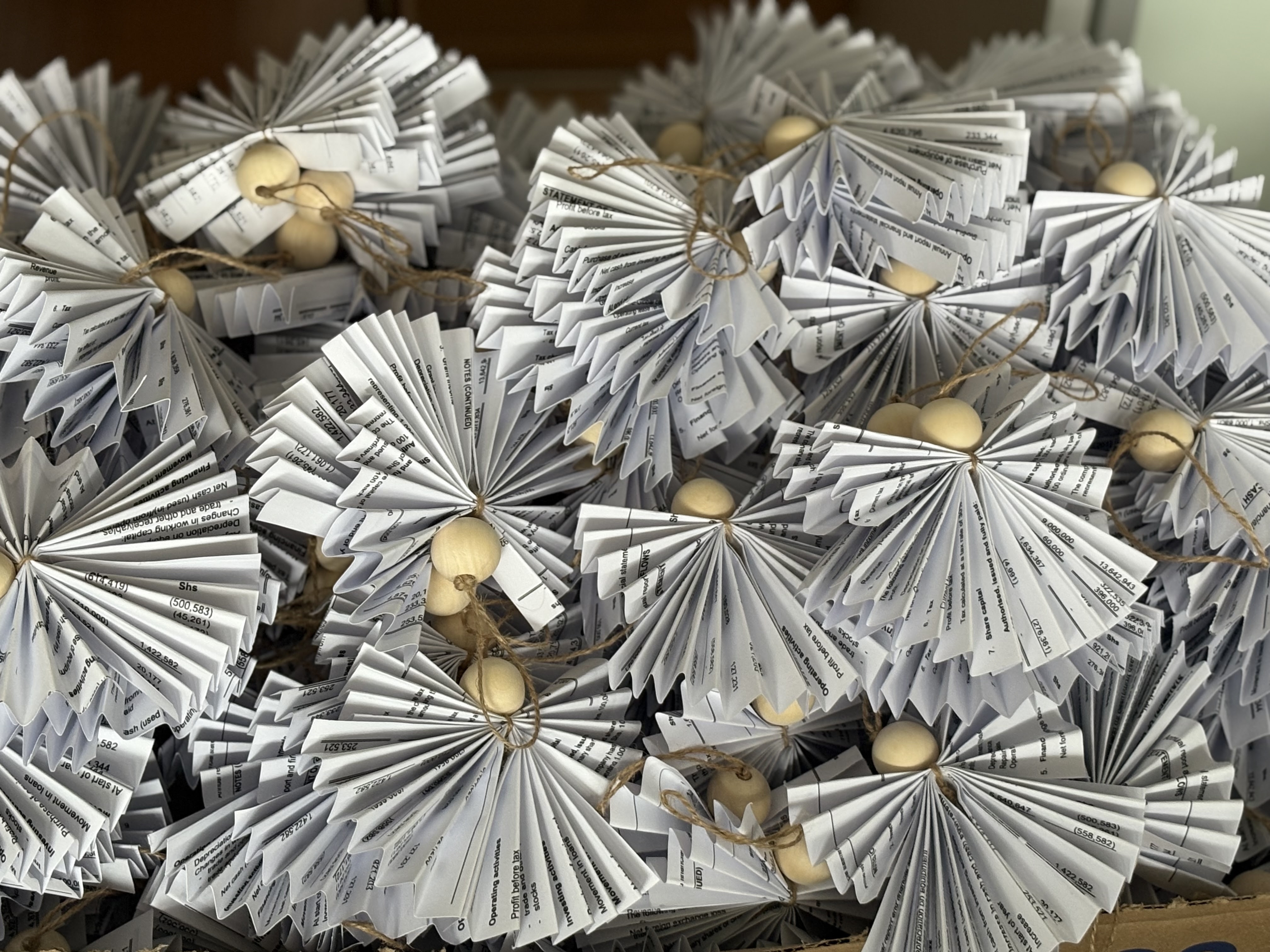 Folded paper angels waiting to be sent to Impacc donors