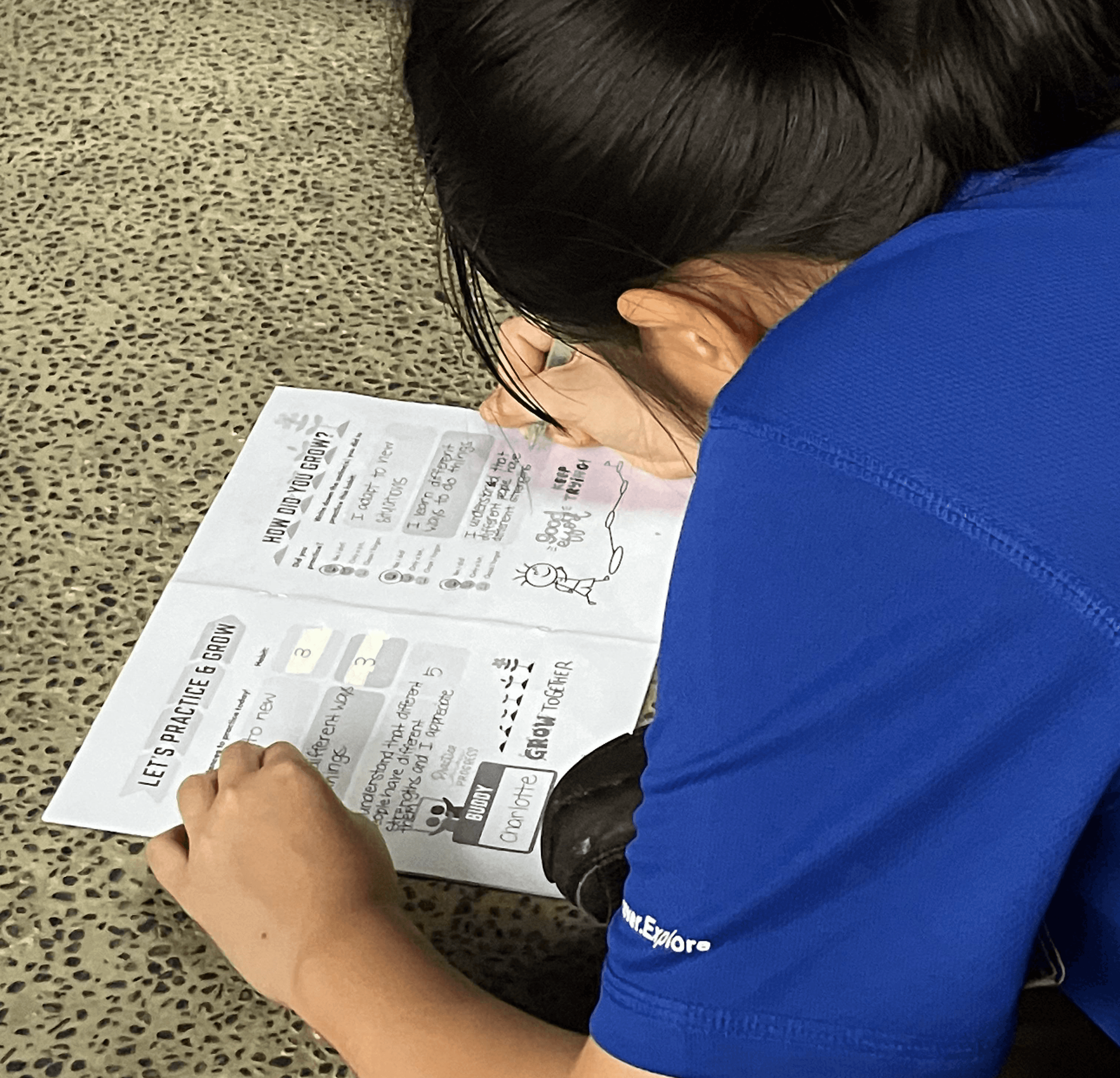 Close-up of a dark green leaf showing its textured surface and central vein against a muted background.