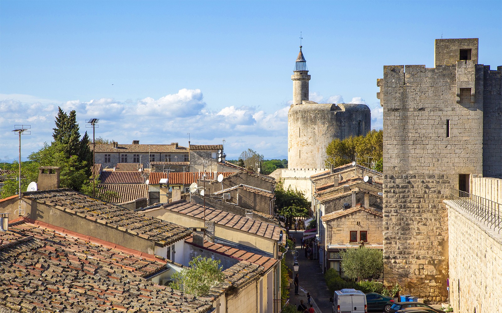 Towers and ramparts of Aigues-Mortes with view of medieval stone structures and rooftops.