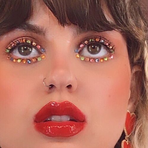 Silhouetted crowd observes pyramid through large windows.