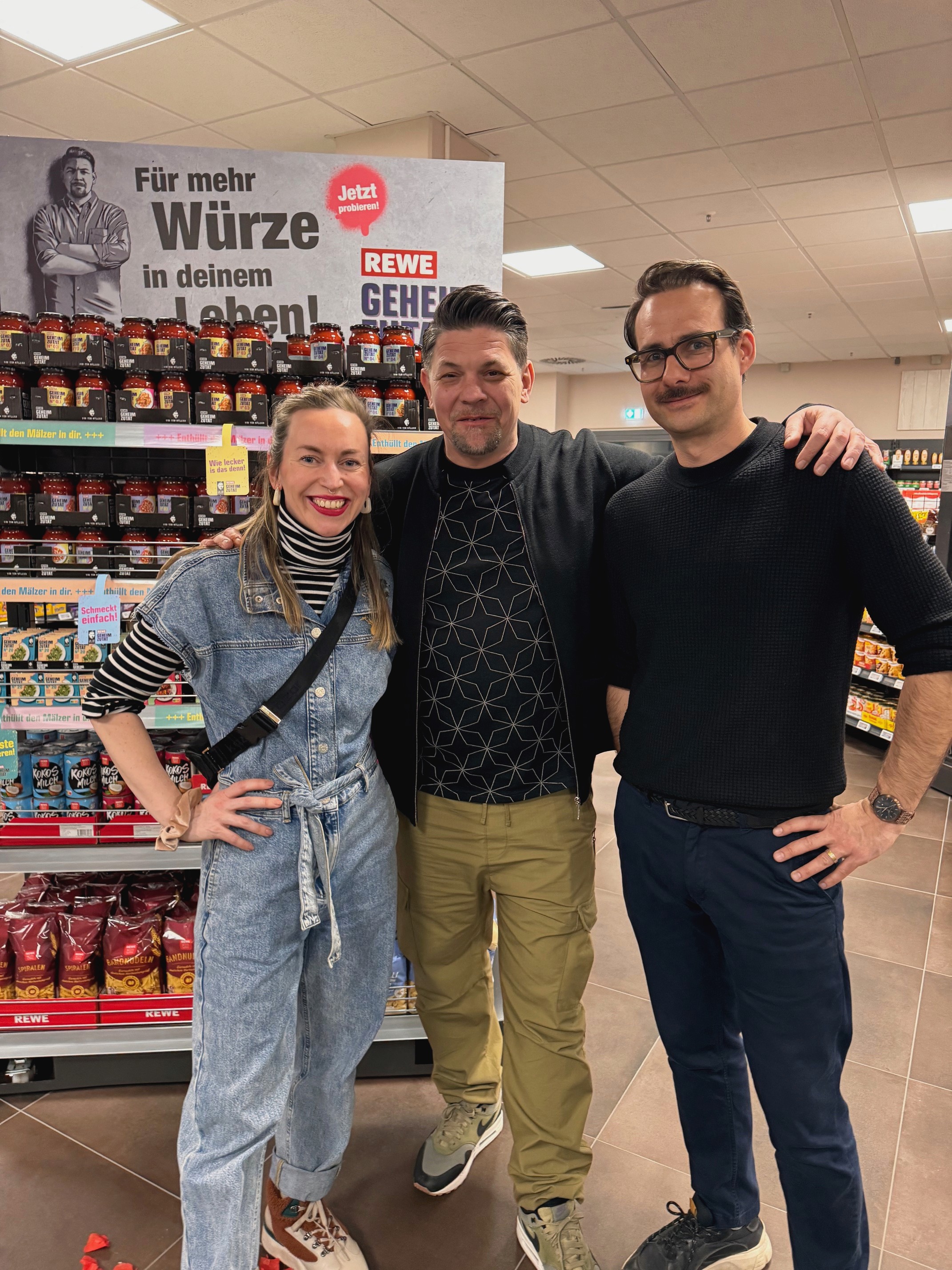 Behind-the-scenes photo with Tim Mälzer and the production team during a retail campaign shoot.