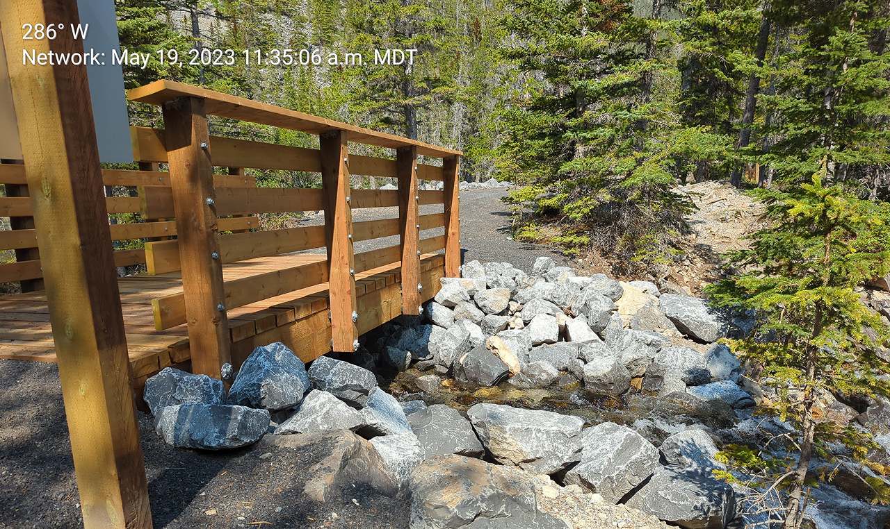 Wooden bridge structure with riprap abutment protection on Grassi Lakes trail refurbishment