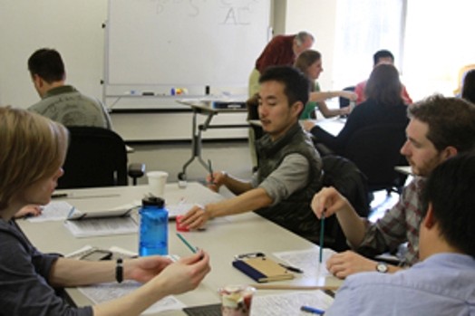 A photo of a group of students sketching and drawing typography letters.