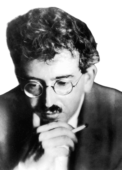 Black and white portrait of a man with tousled hair and round glasses, holding a cigarette while gazing downward in a contemplative pose. His expression is introspective, with a shadowed face that enhances the mood of intellectual depth. The soft focus and dim lighting add an artistic, reflective quality to the image.