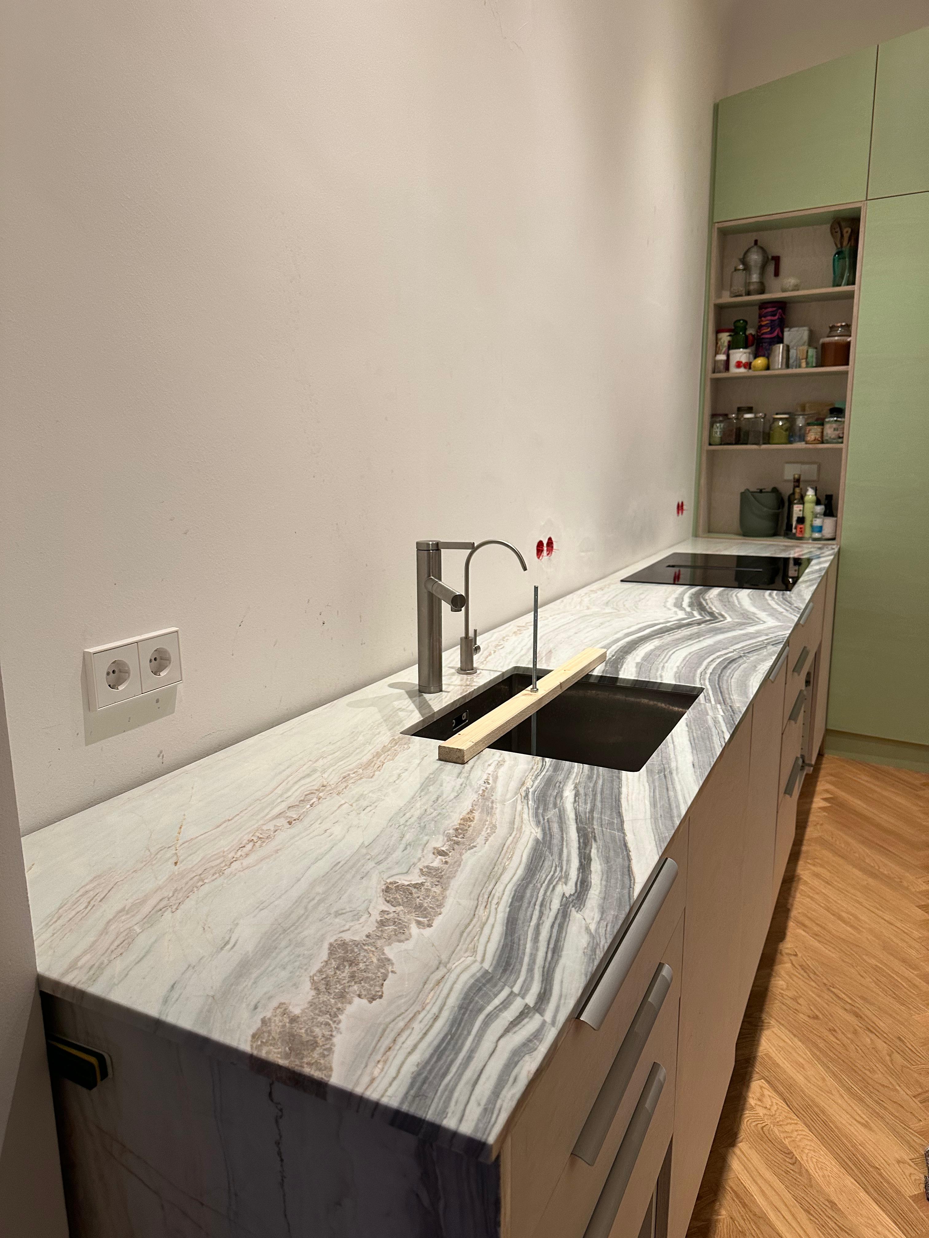Stainless steel sink with faucet.