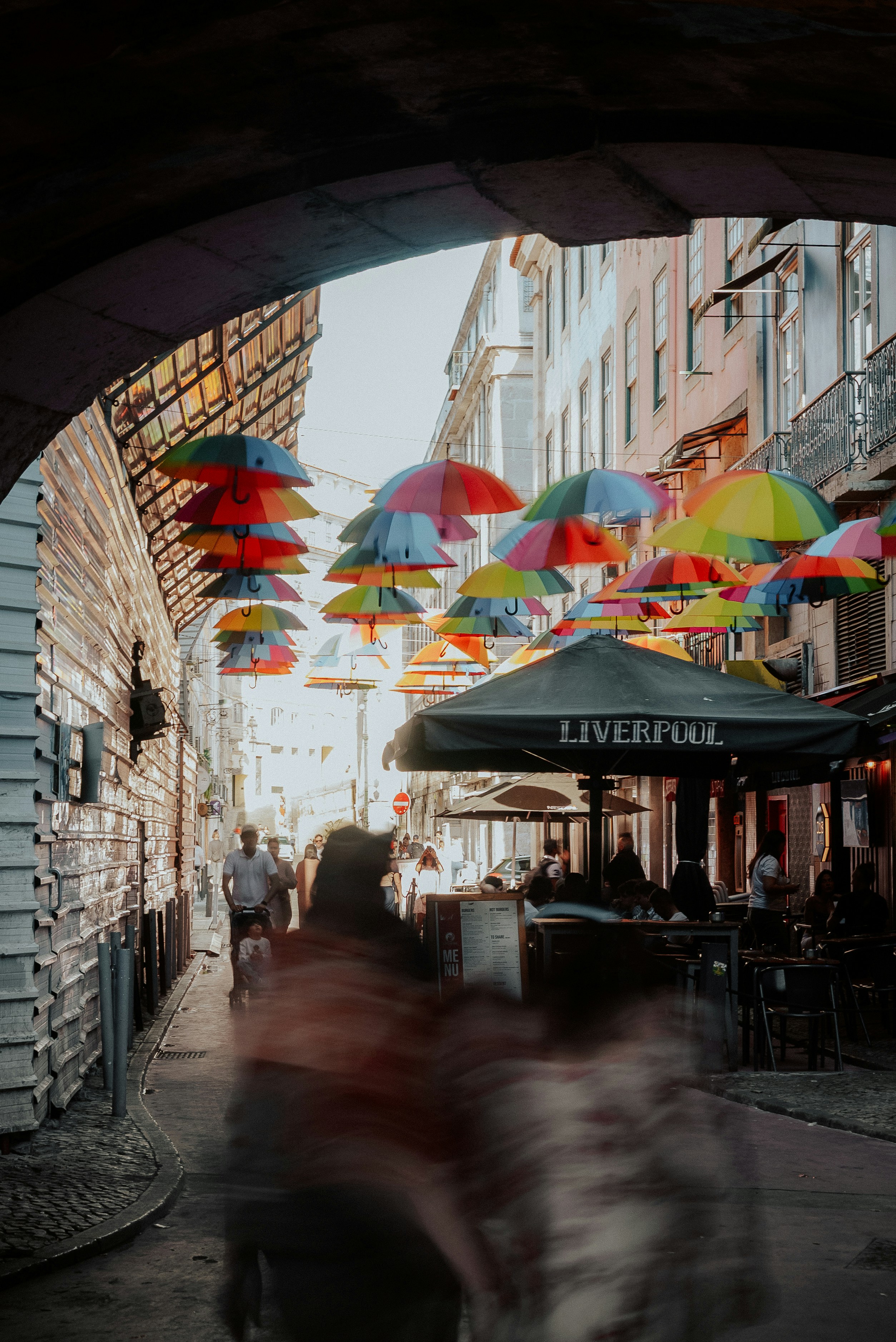 Colorful umbrellas suspended over a bustling city street