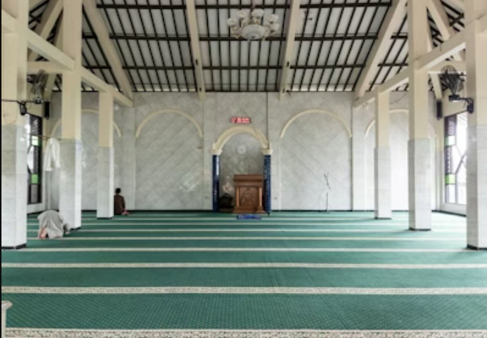 man in black crew neck t-shirt and blue shorts holding woman in white and red