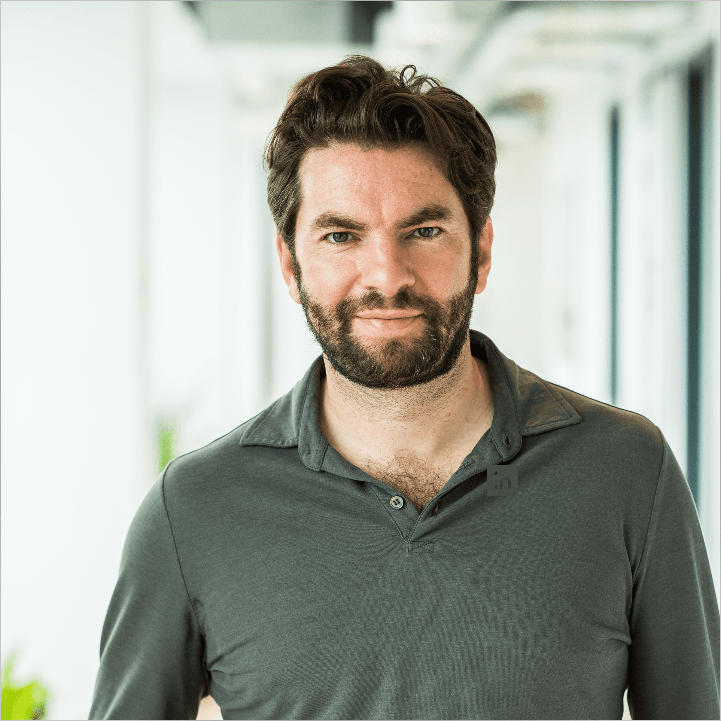 a man in a suit posing for a picture