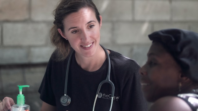 A smiling healthcare professional wearing a stethoscope in a care setting, representing care managers navigating CQC inspections