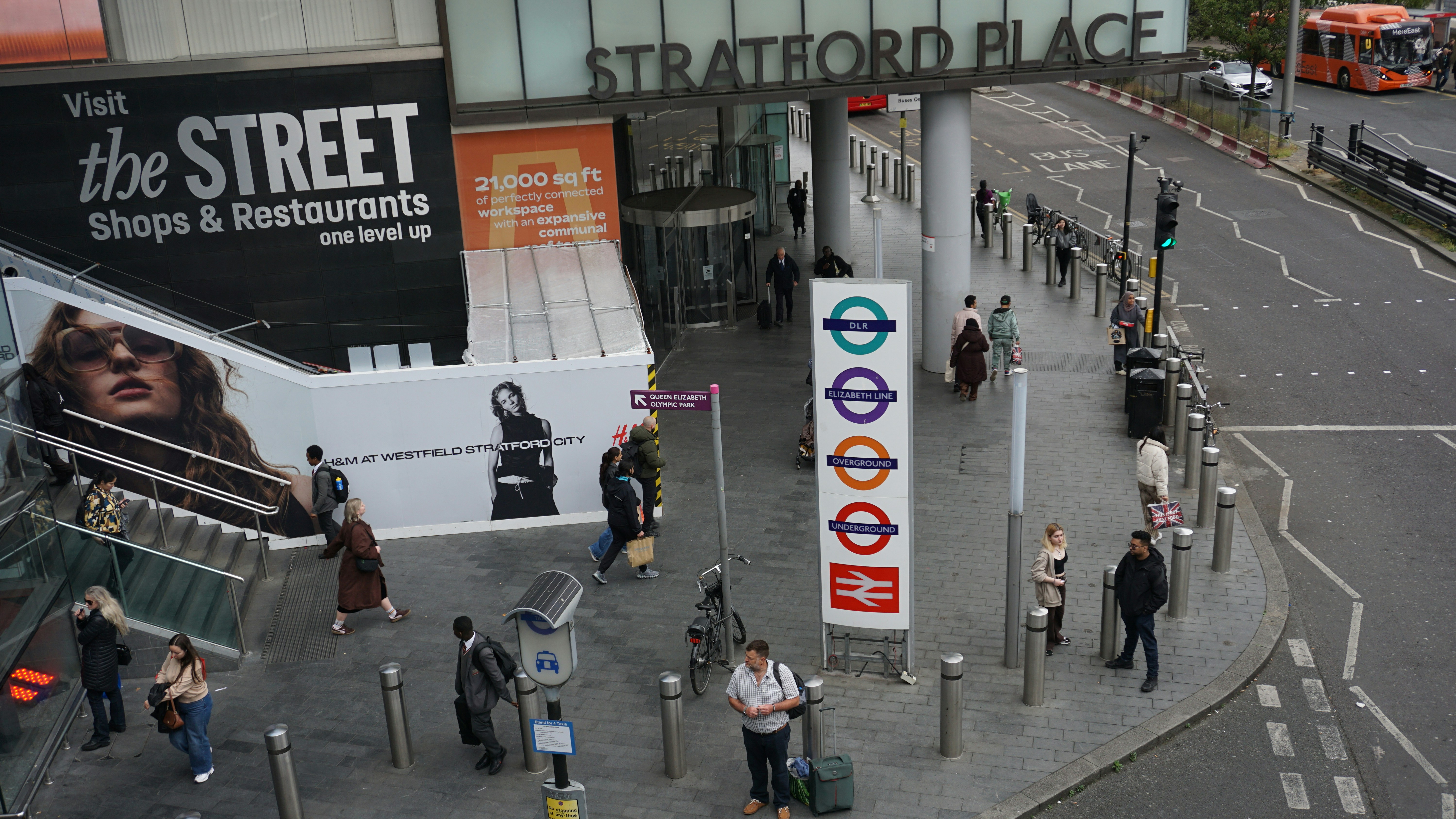 Street scene with people, stratford place building, and underground sign.