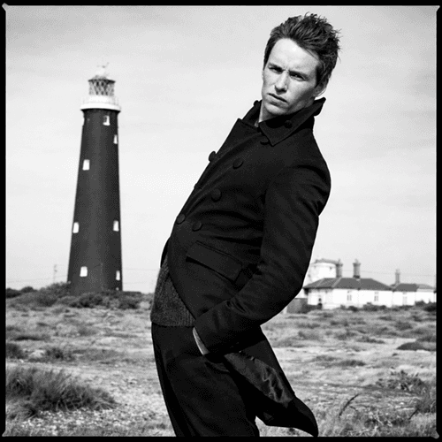 a row of posters on the side of a building