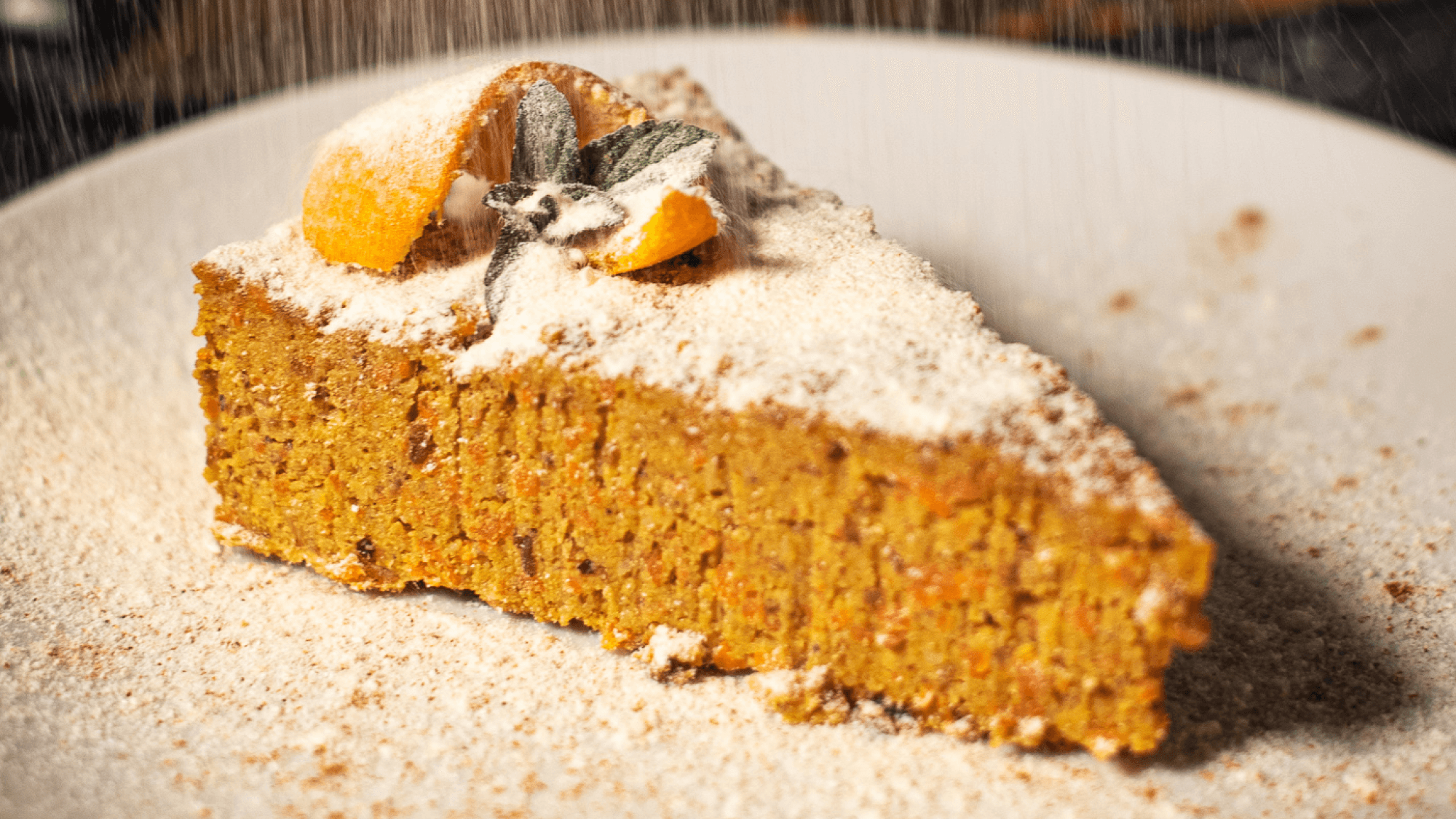 Dusted with coconut, a slice of raw vegan carrot cake with cinnamon
