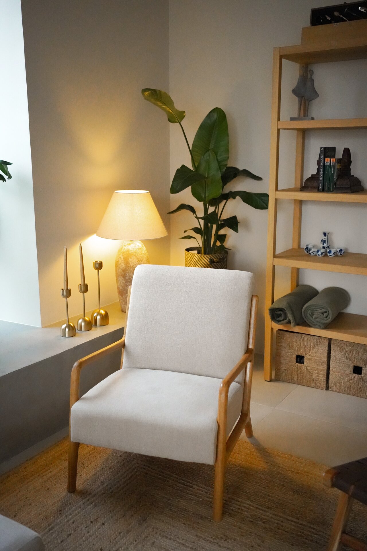 Reading corner with armchair and soft lighting at Villa Flora villa interior