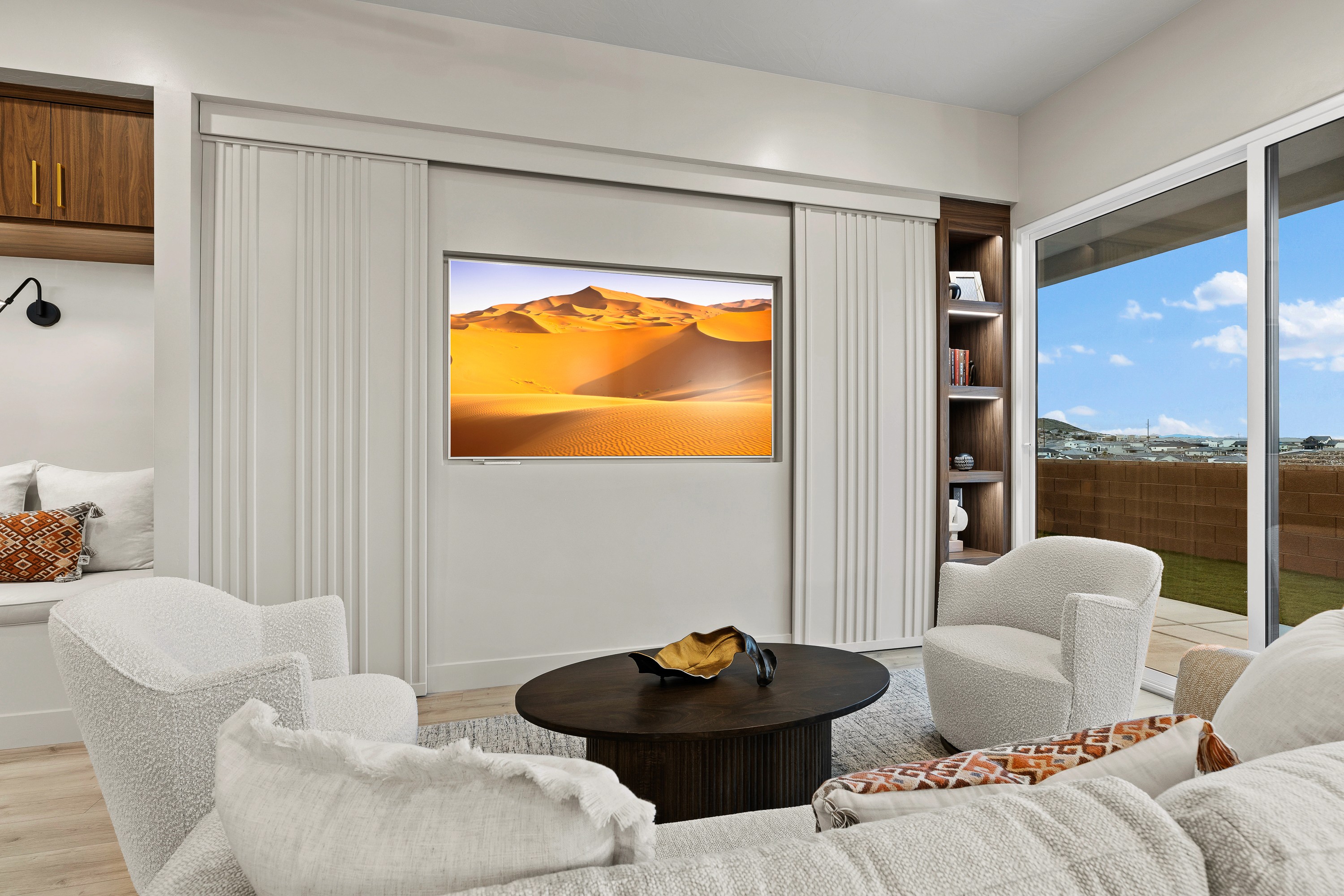 Great room inside The Painted Horizon in Hurricane, Utah featuring a built-in entertainment center and open living space.