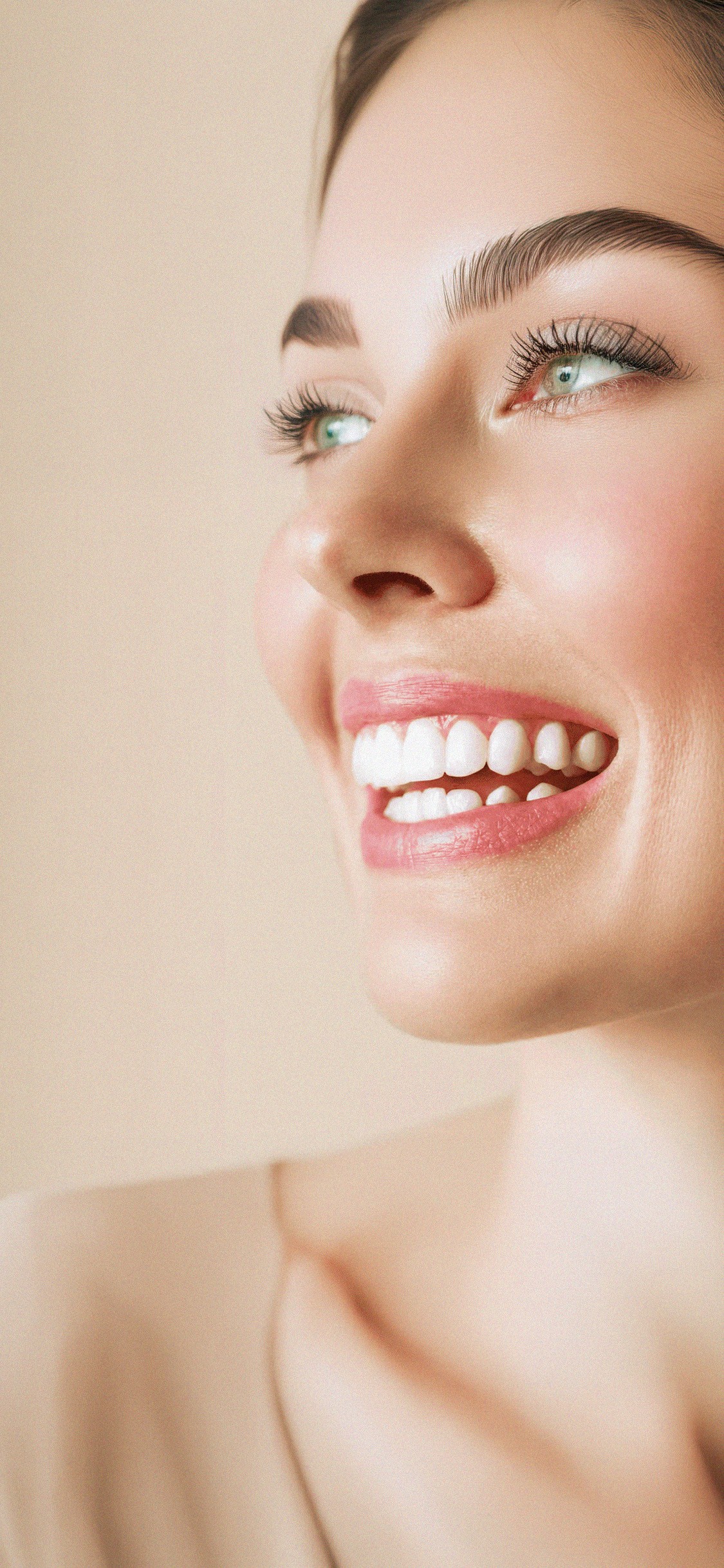 Person smiling warmly in sunlight