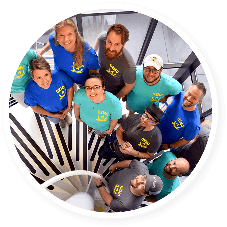 Ozmo employees looking up from spiral stairs