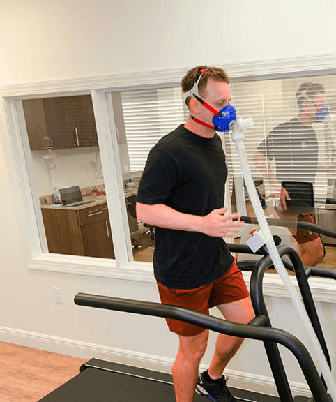 Dr. J conducting VO₂ Max fitness testing at Harper Health Naples clinic.