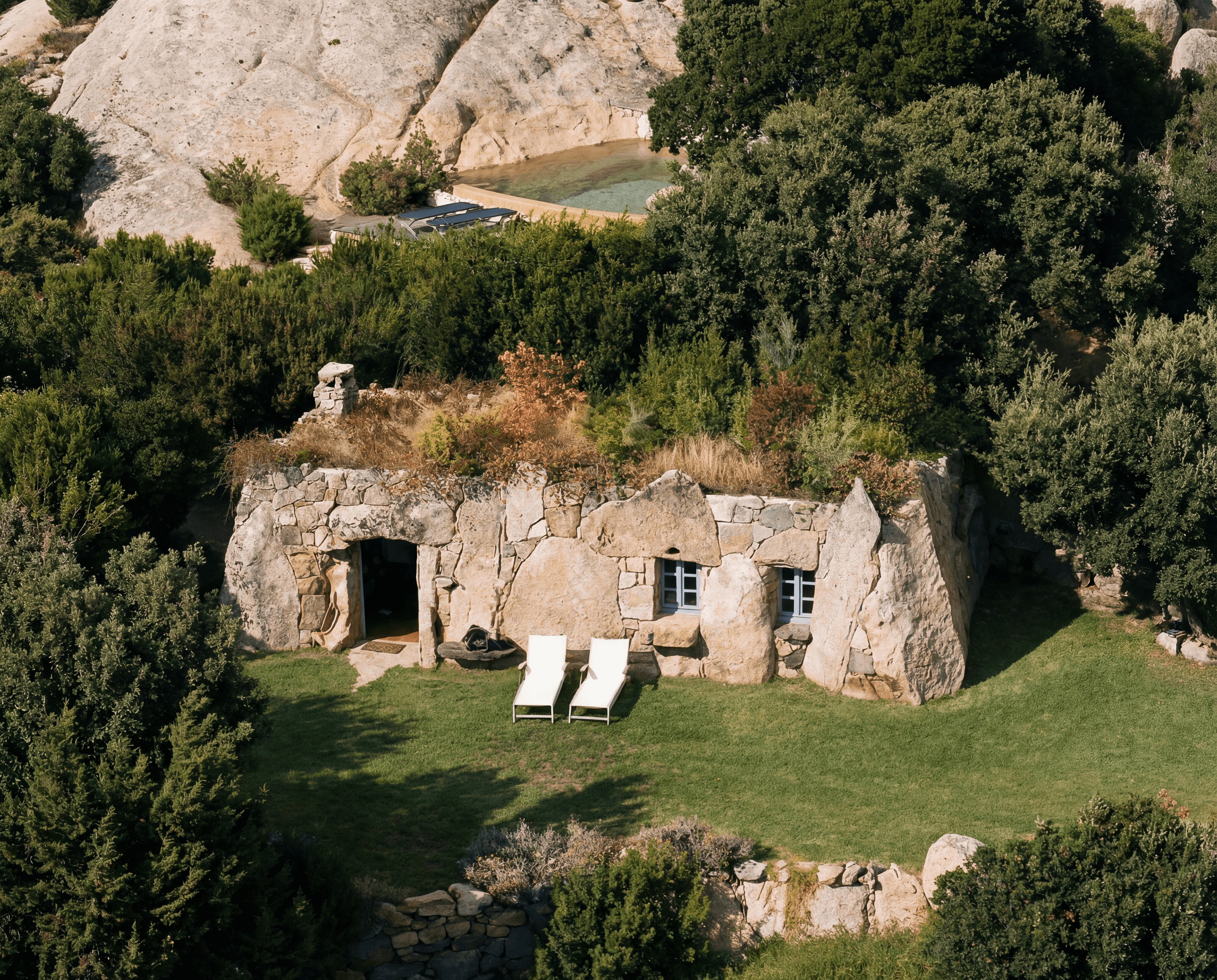 landscape with brown house surrounded by green leafed trees during daytime