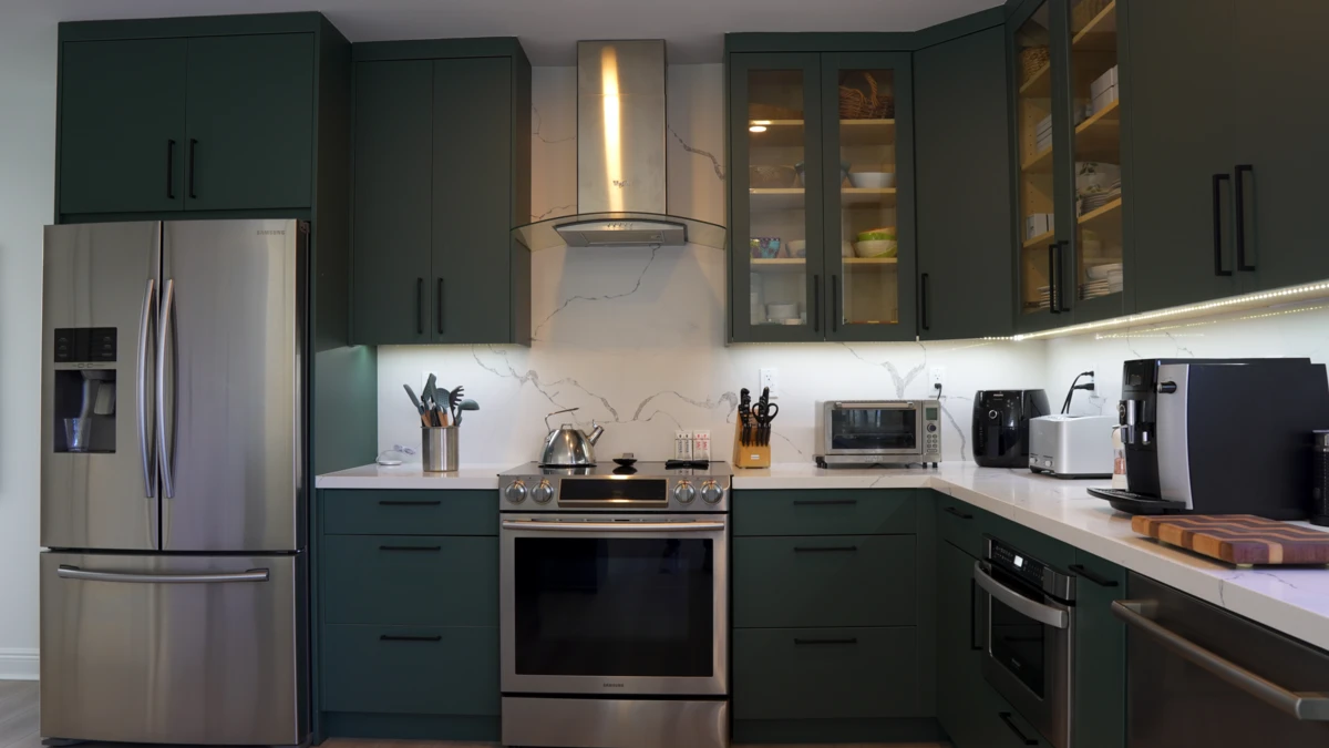 Newly Remodeled Kitchen with Flat Panel Cabinets on the Verde Salvia color with under cabinet lighting and statuario classique countertop