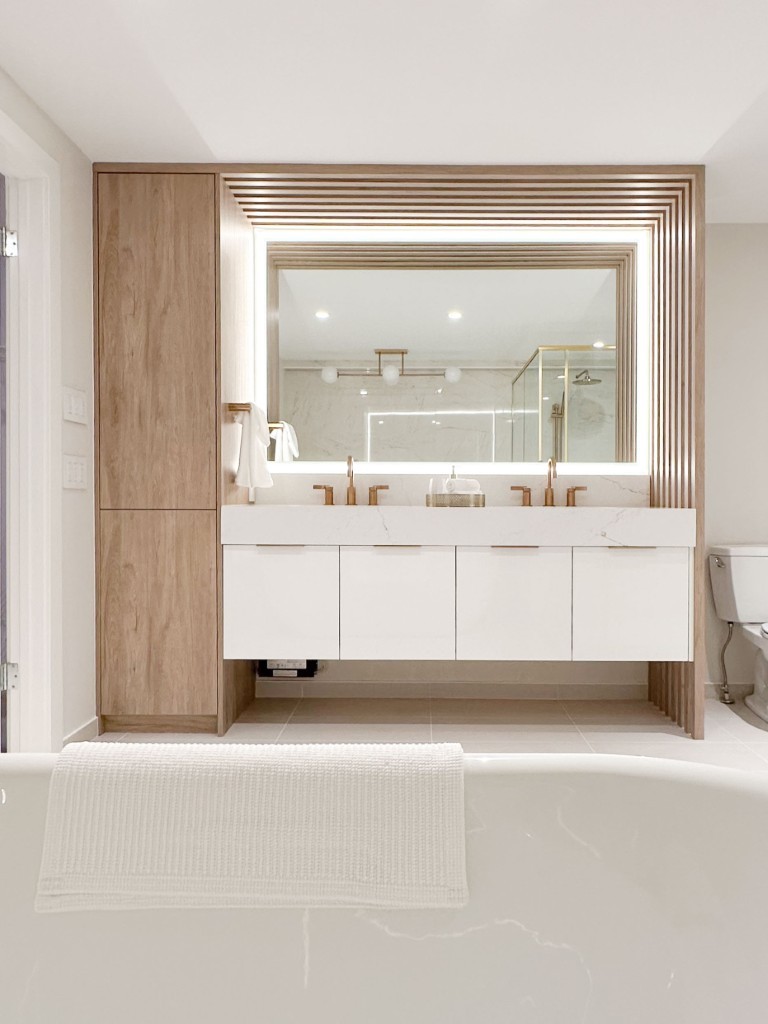 Image of Luxurious primary ensuite bathroom design by KHD Homes featuring a modern double vanity and spa-like tub.