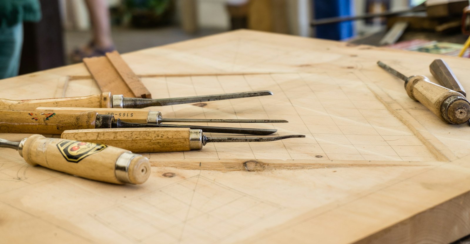 Hand tools laid out on a wooden workbench