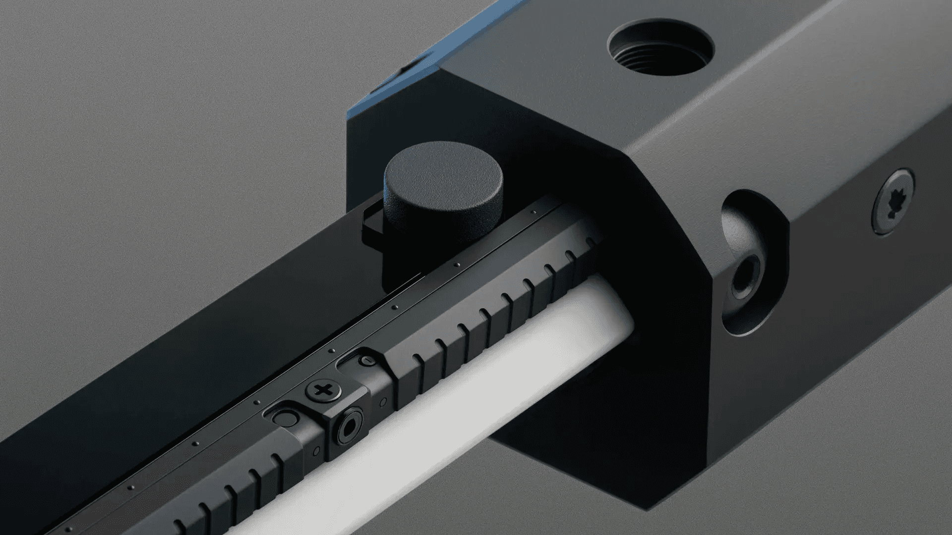 Close up of black metal mechanism with knob and sliding rail