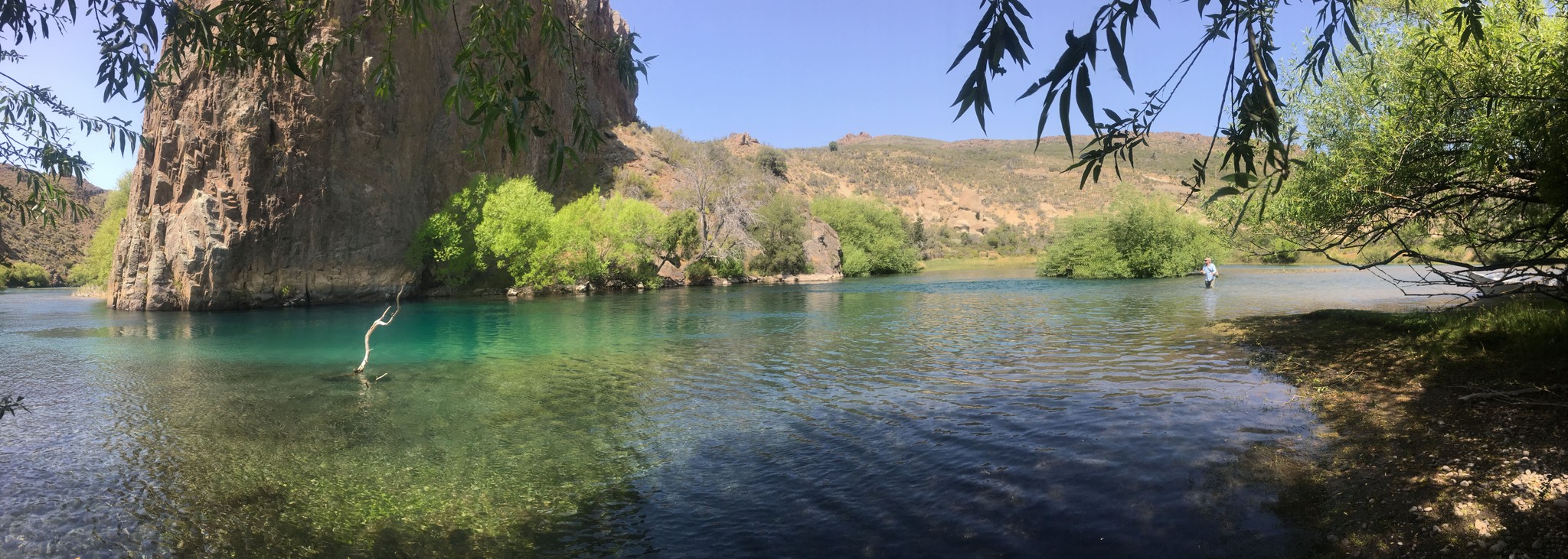 a river running through a valley surrounded by mountains