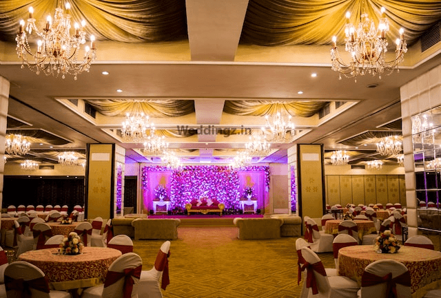 <img src="hotel-banquet-hall.png" alt="A spacious hotel hall filled with neatly arranged tables, elegant lighting, and luxurious interiors." />
